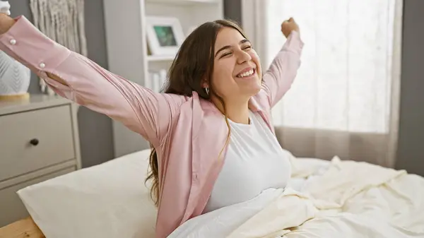 Joyful Young Woman Stretches While Sitting Bed Embodying Comfort Happiness — Stock Photo, Image