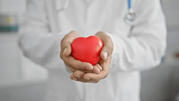 Healthcare Professional Man Lab Coat Holding Red Heart Symbol Clinic — Stock Photo, Image