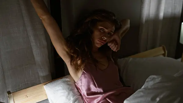 Tired Young Woman Satin Pajamas Waking Dimly Lit Bedroom Embodying — Stock Photo, Image