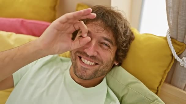 Cheerful Young Caucasian Man Playfully Peeking Gesture Hand Bedroom Wearing — Stock Video