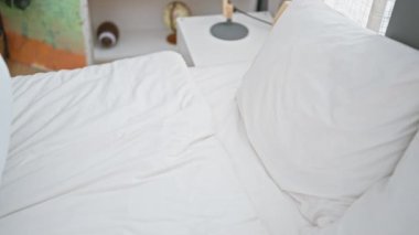 İspanyol bir adam, parlak, rahat bir yatak odasında huzur içinde uyuyor. Rahatlama ve rahatlama hissi yayıyor..