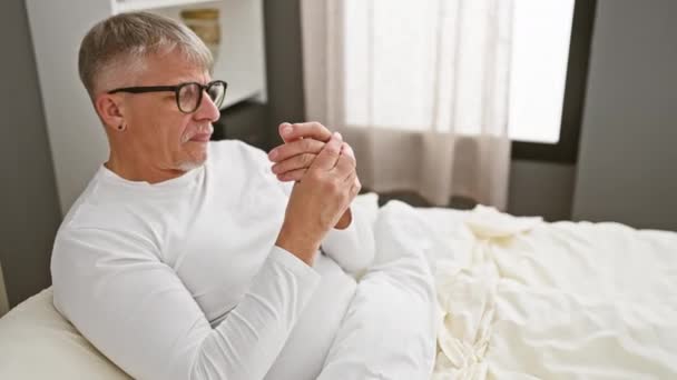 白发苍苍的中年男子穿着睡衣 手指头关节酸痛 在卧室里忍受着关节炎 — 图库视频影像