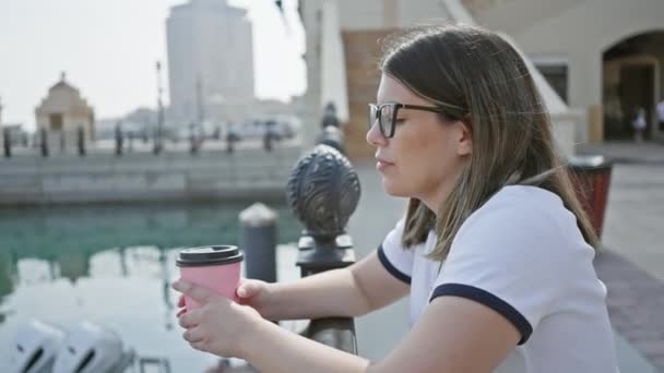 Eine Brünette Frau Genießt Kaffee Wasser Mit Moderner Doha Architektur — Stockvideo