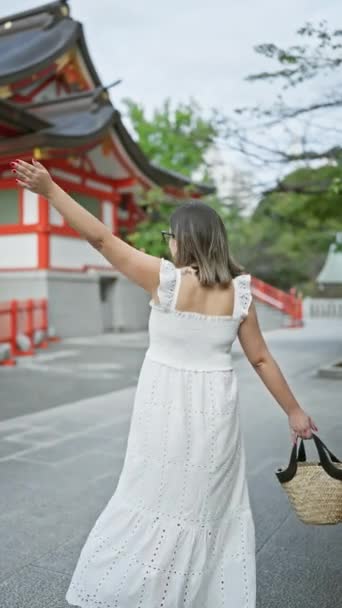 Весела Красива Іспаномовна Жінка Окулярах Запрошує Дружнім Жестом Японського Храму — стокове відео