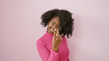 Davetkar ifade, gözlüklü neşeli Afro-Amerikalı kadın, hoş bir el hareketiyle işaret ediyor, 'buraya gel' ve onun mutlu gülümsemesini paylaş.!