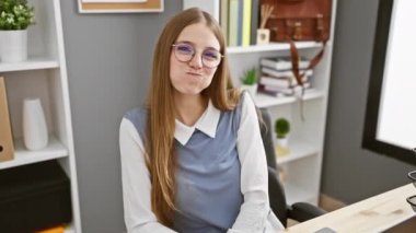 Komik ofis soytarıları, deli gibi surat yapan genç sarışın iş kadını komik şişmiş bir ifade için yanaklarını havayla şişiriyor. # Mutlu kahkahalar işyerinde, suratsız bir şişkoyla #!