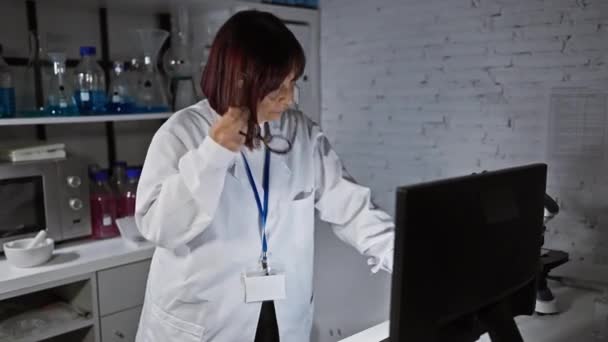 Focused Woman Lab Coat Works Attentively Computer Modern Laboratory Setting — Stock Video