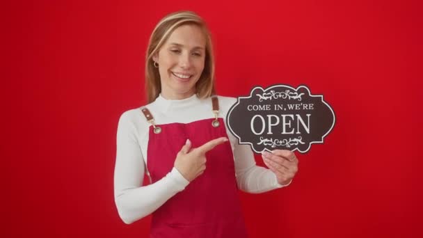 Young Blonde Woman Wearing Apron Holding Open Blackboard Smiling Happy — Stockvideo