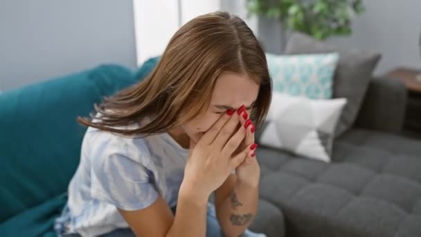 Upset Caucasian Woman Sitting Indoors Sofa Covering Her Face Hands — Stock Video