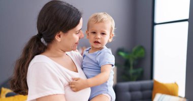 Mother and son smiling confident standing at home