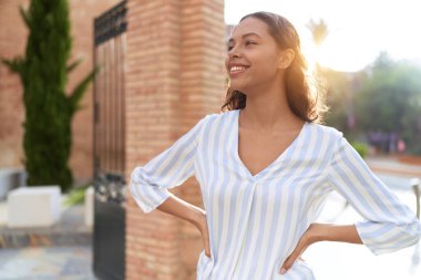 Young african american woman smiling confident looking to the side at street