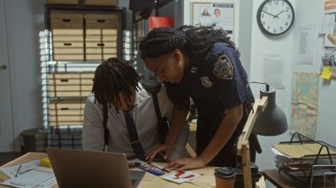 A policewoman and a man investigate a case with evidence on a desk inside a police station. clipart