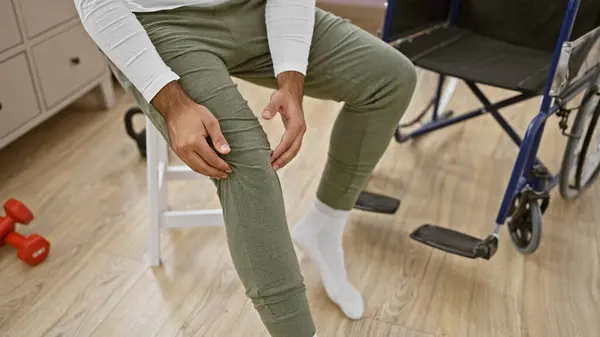 Hispanic Man Hands Gripping Chair Suffering Intense Knee Pain While — Stock Photo, Image