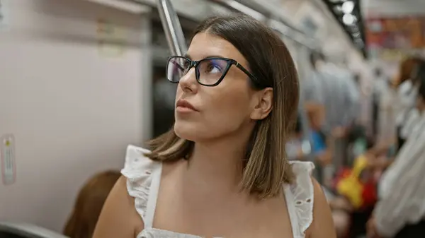 美丽的他的惊慌失措的女人 戴着眼镜 站在地铁中间等待着 城市里一个现代黑发乘客在空荡荡的地铁里的肖像 乘坐公共交通工具旅行 — 图库照片