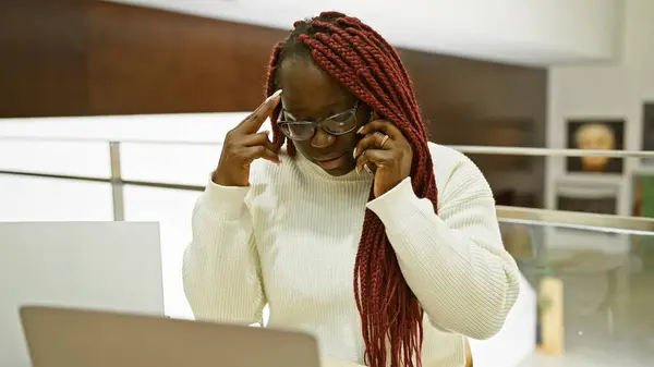 Concentrated African American Woman Braids Talking Phone Modern Office Setting — Stock Photo, Image