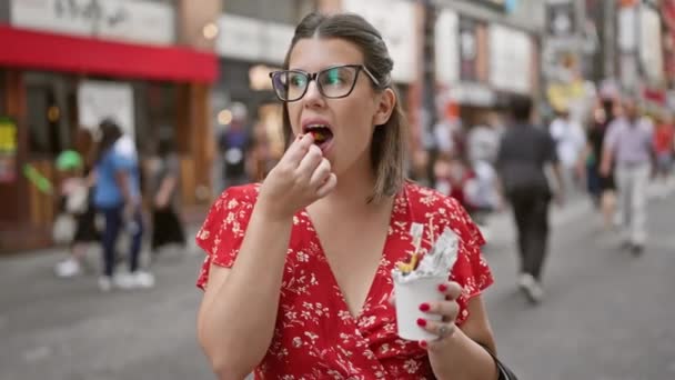 Stunning Hispanic Woman Savors Sweet Potato Snack Her Eyeglasses Buzzing — Stock Video