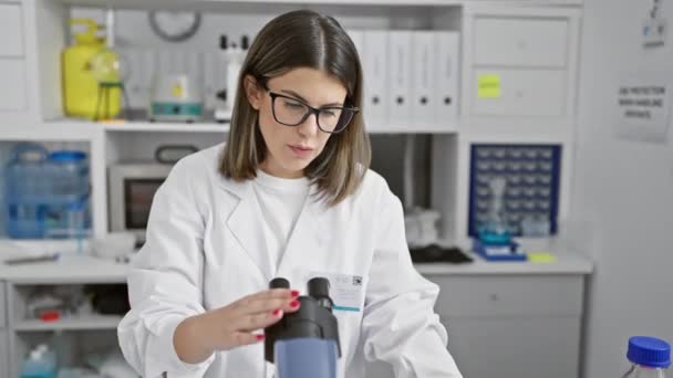 Concentrated Female Scientist Using Microscope Clinical Laboratory Setting Reflecting Healthcare — Stock Video