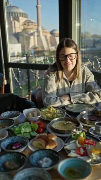 Young Woman Enjoys Traditional Turkish Breakfast Restaurant View Hagia Sophia — Stock Video