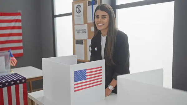 Young Hispanic Woman Smiles American Polling Station Flags Electoral Information fotografii de stoc fără drepturi de autor