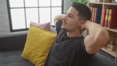 Rahatlamış bir İspanyol adam modern bir oturma odasında keyfine bakıyor, rahat ve tarz sahibi..