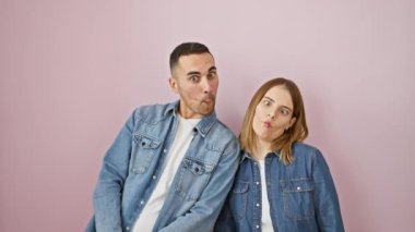 Komik bir aşk! Kot gömlek giyen güzel bir çift pembe arka planda dikilip aptal balık suratları yapıyorlar. Çılgın, komik eğlence.!