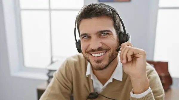 stock image Handsome hispanic man with beard smiling in office wearing headset