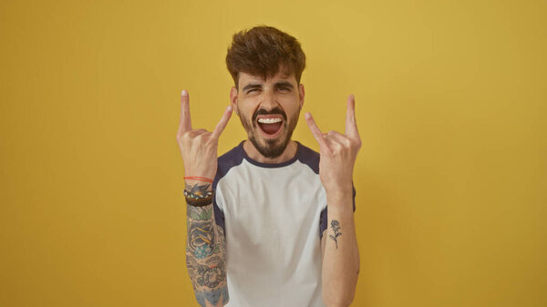 Bearded Tattooed Man Casual Clothing Showing Rock Signs Vibrant Yellow Stock Picture