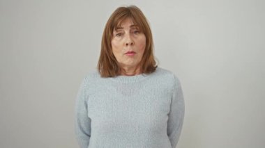 Kısa saçlı komik orta yaşlı kadın, kendine güvenen bir süveter giyiyor, yanaklarını şişirerek komik bir yüz ifadesi takınıyor. İzole edilmiş beyaz arkaplan üzerindeki çılgın ifade.