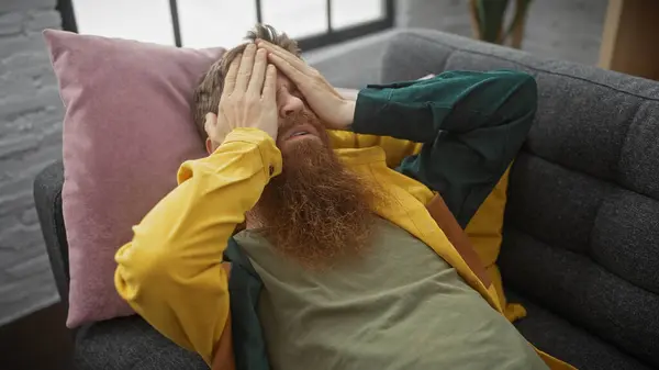 stock image Bearded redhead man stressed indoor couch