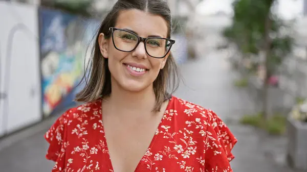 stock image Beautiful hispanic woman wearing glasses, standing and smiling confidently on famous dotonbori street, osaka, a portrait of happiness, success, and joy