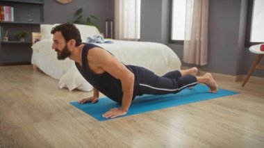 Modern yatak odasında yoga yapan sakallı bir adam huzur ve sağlıklı bir yaşam tarzı sergiler..