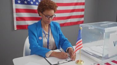 İkna olmuş ve kendine güveni tam bir Afrikalı Amerikalı kadın aday bir seçim merkezindeki hükümet seçim stratejisini yansıtıyor.