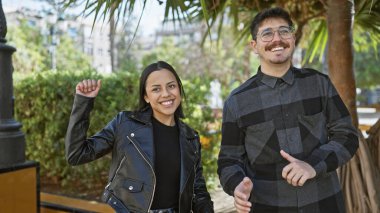 Neşeli bir adam ve kadın güneşli bir şehir caddesinde dans ediyorlar. Aşkı ve mutluluğu dış görünüşlerinde somutlaştırıyorlar..