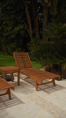 Gevşeme bereketli bir tropikal bahçeye çağırır, ahşap güneş pansiyonları sakin bir verandada güneş arayanları bekler..