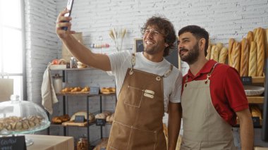 Erkekler pastanede selfie çekiyorlar, önlük giyiyorlar, taze ekmek ve pastalarla çevrelenmişler, beyaz tuğlalı duvarları ve ahşap rafları olan kapalı bir ortamda dost canlısı fırıncıları tasvir ediyorlar..