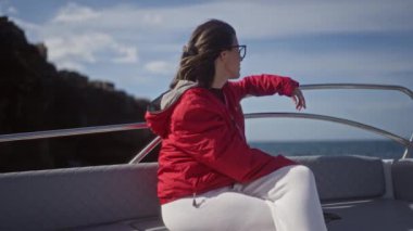 Genç bir İspanyol kadın Polignano 'daki güzel bir koyda tekne gezintisinden zevk alıyor. Bir kısrak, puglia, İtalya, arka planda deniz ve yakınlardaki uçurumlar..
