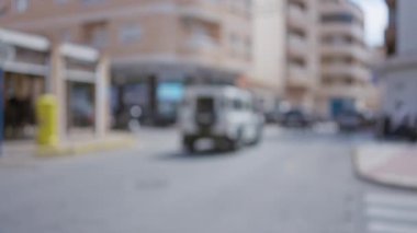 Şehir sokaklarının bulanık arkaplanı binalar ve arabalarla şehir yaşamını yumuşak odaklı bokeh efektiyle gösteriyor