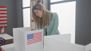 A young woman votes in an american electoral college room with flag banners. clipart