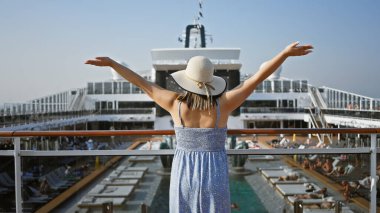 A young adult woman enjoying her vacation on a cruise ship deck under a clear sky. clipart