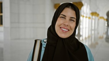 Abu Dabi 'de İslami bir camide tesettüre girmiş gülümseyen genç bir İspanyol kadın..
