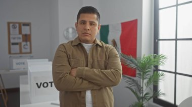 Meksiko bayrağı kapalı bir odada kollarını kavuşturmuş İspanyol bir adam.