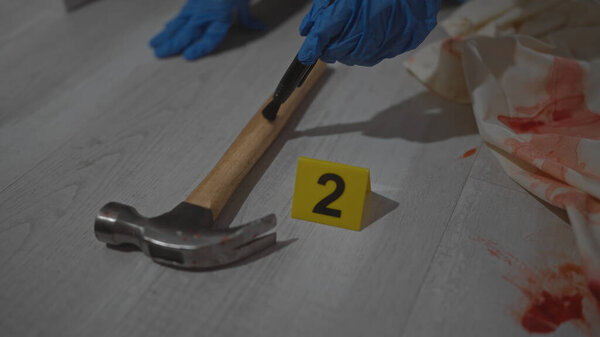 A man investigates a crime scene with gloves, a hammer, blood, evidence, number, indoors, mystery, investigation, forensic, violence