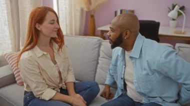 Irklar arası bir çift, aşk ve mutluluk gösteren heyecanlı bir kadına yüzük veren adamla oturma odasında aşk ve evlilik teklifi yapıyor.