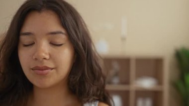 Çekici genç İspanyol kadın, sakin bir spa ortamında rahatlıyor, doğal güzelliğini ve sükunetini bir sağlık merkezinde sergiliyor..