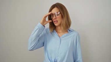 Baş ağrısı, yorgunluk, stres ve soyutlanmış beyaz arka plan yüzünden hayal kırıklığı nedeniyle ayakta duran ve gözlerini ovuşturan genç sarışın kadın. 