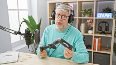 Telsiz stüdyosunda elinde kumanda olan orta yaşlı bir adam.