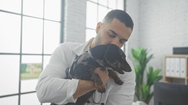 İspanyol adam veteriner kliniğinde köpeğini sevgiyle tutuyor.