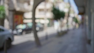 Bokeh 'in gün ışığında sakin ve odak dışı bir şehir manzarası yarattığı bir şehir sokağının bulanık arkaplanı.