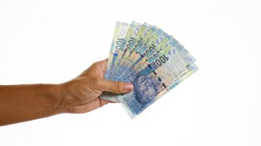 El ele tutuşan Güney Afrika rand banknotları beyaz arka planda izole edilmiş.
