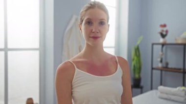 Cilt bakımından hoşlanan bir kadın, parlak bir gülümsemeyle kaplıcada, rahatlatıcı bir iç güzellikle çevrili, güzel sarışın beyaz bir yetişkin, kapalı bir güzellik merkezinde huzurlu anları yakalıyor.